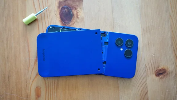 Fairphone 6 Plus facedown on a table, backplate partially removed