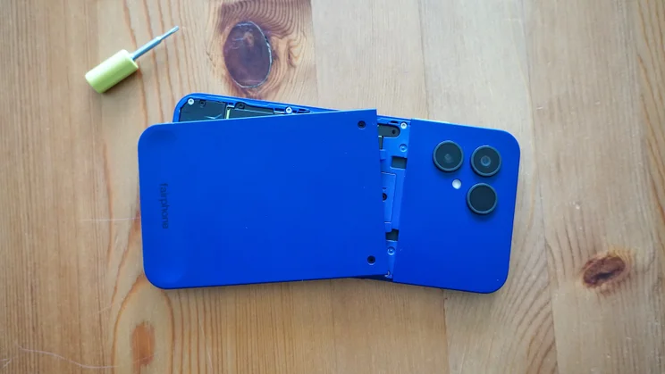 Fairphone 6 Plus facedown on a table, backplate partially removed