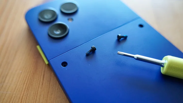 Fairphone 6 Plus with screws removed, screwdriver in foreground