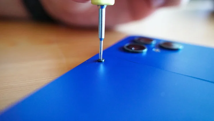 Screwdriver removing screws on the Fairphone 6 Plus