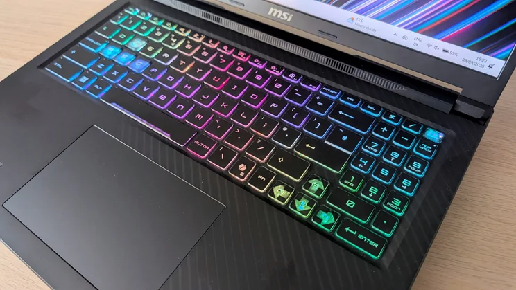 Close-up of the MSI Raider 16 HX per-key RGB keyboard, numpad and touchpad, with the WASD keys lit in a contrasting colour