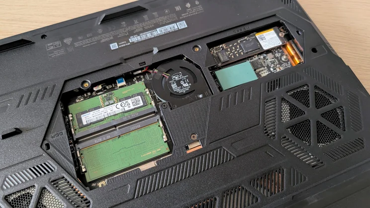 Underside of the MSI Raider 16 HX with the service panel removed, showing two DDR5 SODIMM memory slots, a cooling fan and a Gen 5 M.2 SSD