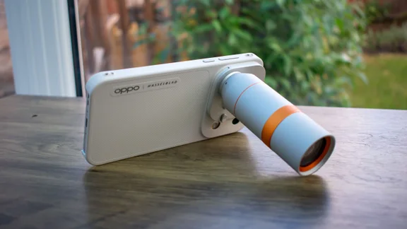 Oppo Find X10 Pro Max with external teleconverter attached, propped on desk