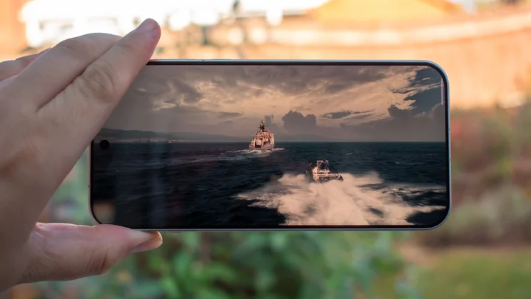 Oppo Find X10 Pro Max in hand in landscape orientation, displaying a TV show