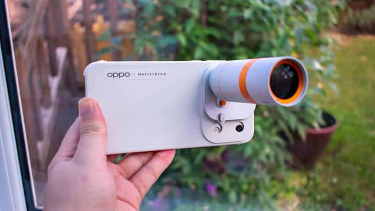 Angled view of the Oppo Find X10 Pro Max in hand with external teleconverter attached