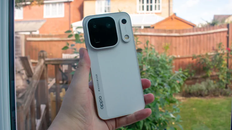 Oppo Find X10 Pro Max in hand, rear view, in front of a window