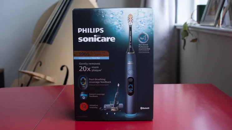 The Philips Sonicare DiamondClean 9900 Prestige electric toothbrush box, on a red table