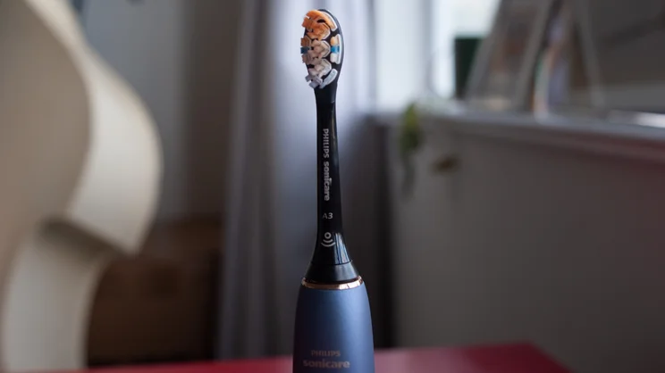 A closeup of the Philips Sonicare DiamondClean 9900 Prestige electric toothbrush's brush head, stood upright