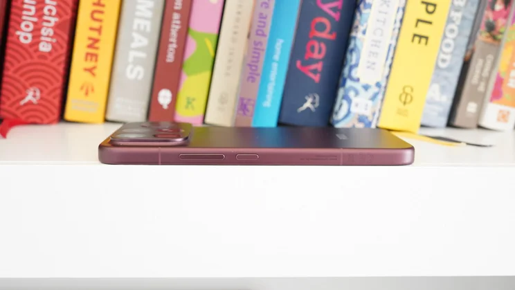 Poco F9 Ultra face down on a bookshelf, side view