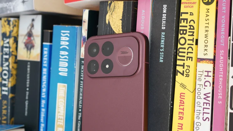 Poco F9 Ultra leaning against some books, rear view