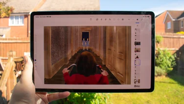 Samsung Galaxy Tab S12 Plus in hand, displaying digital art
