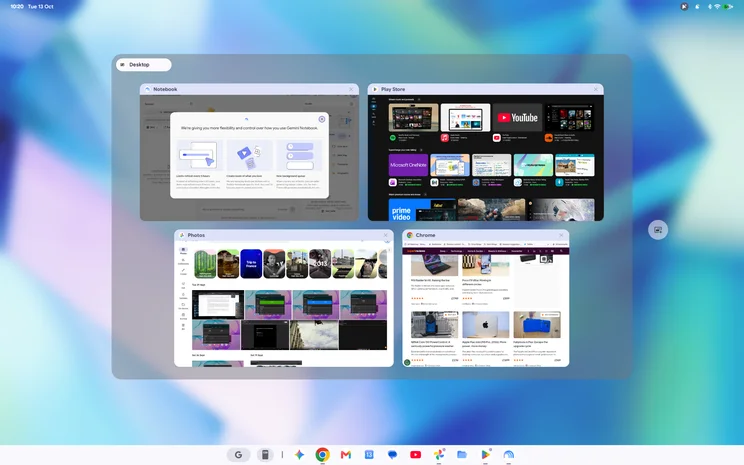 Googlebook OS' multi-desktop view showing four open apps as thumbnails: Gemini Notebook, Play Store, Photos and Chrome, above the bottom shelf of app icons.