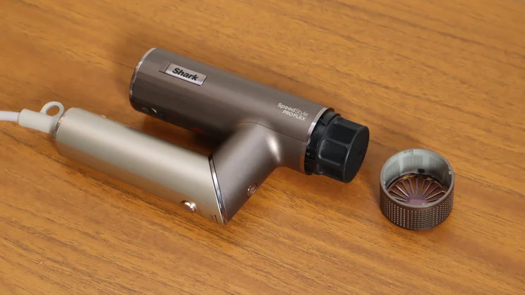 The Shark Speedstyle Pro Flex hair dryer, folded and with filter cover removed, on a wooden table