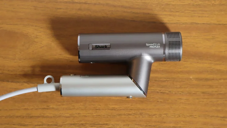 A bird's eye view of the Shark Speedstyle Pro Flex hair dryer, folded up, on a wooden table