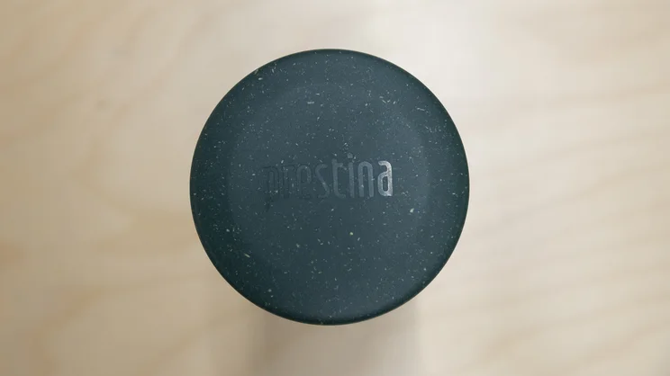 A bird's eye view of the Wacaco Prestina coffee maker - with lid attached - standing upright on an office table