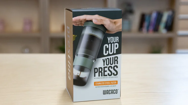 The Wacaco Prestina coffee maker, in its box, on an office table