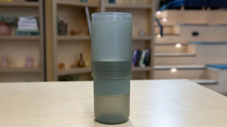 The Wacaco Prestina coffee maker standing upright on an office table