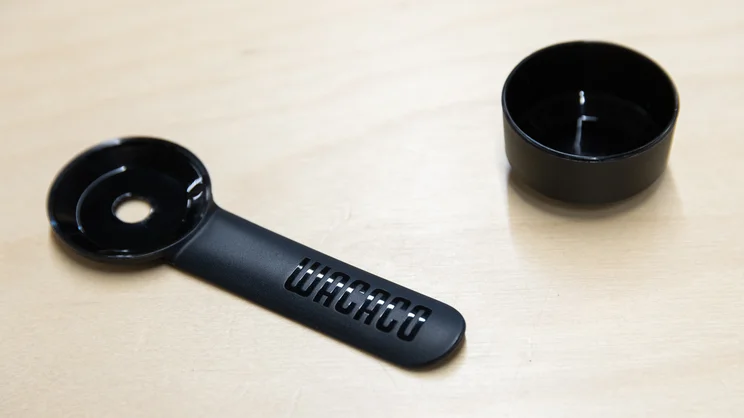 A closeup of the Wacaco Prestina coffee maker's stir-spoon - with spoon part detached - on an office table