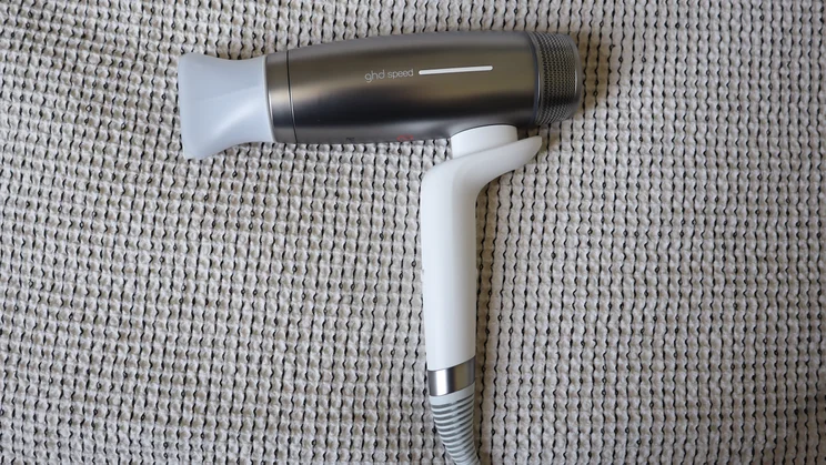 A bird's eye view of the GHD Speed Ionic hair dryer, on a grey blanket