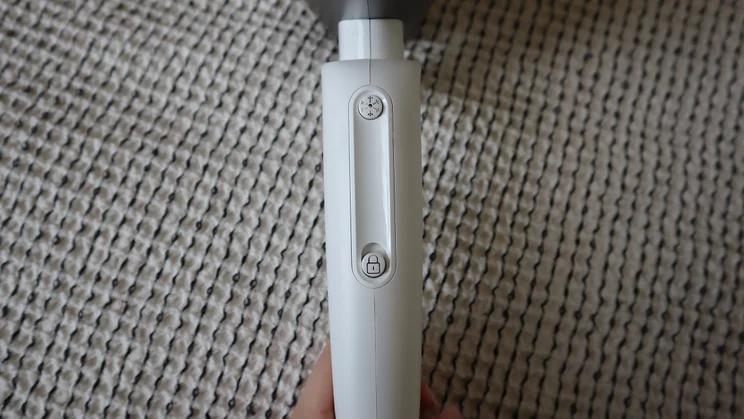 A closeup of the GHD Speed Ionic hair dryer's cool shot controls
