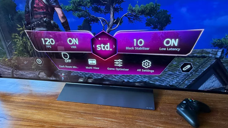 Close-up view of the Game Optimiser dashboard menu overlaid on a video game screen on the 77in LG C6 OLED featuring Primary RGB Tandem OLED technology, showing real-time gaming stats like 120 FPS and VRR enabled