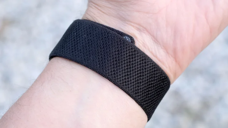 Close-up of the fine textured weave on a Whoop 5.0 black elastic band worn around the wrist