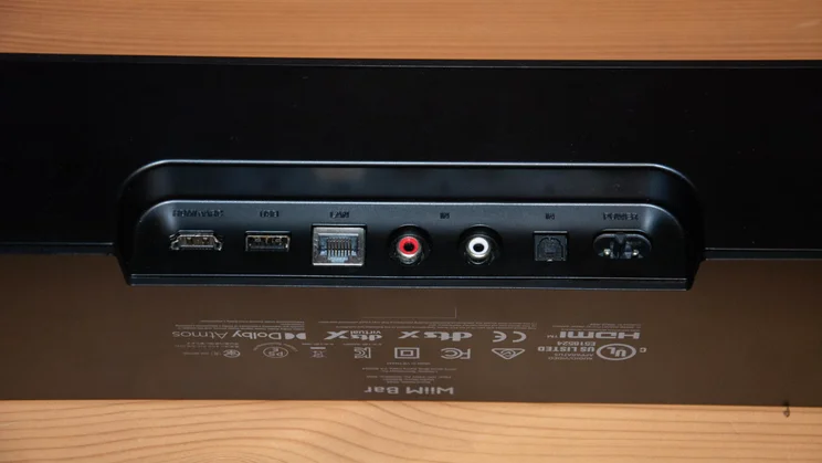 Rear input panel of the black WiiM Bar soundbar, displaying connection ports including HDMI eARC, USB, LAN ethernet, RCA line in, optical in, and power input