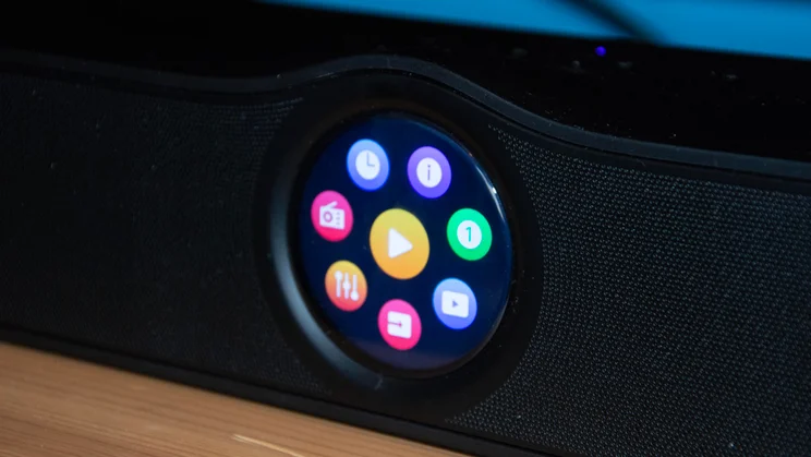 Close-up of the WiiM Bar soundbar's circular display showing a colorful wheel menu with various app and setting icons